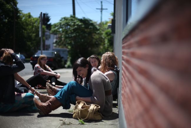 sitting on the sidewalk in the sun